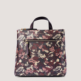 Metallic floral print mini backpack with reverse zip pocket.