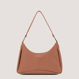 Tan small shoulder bag with elongated D-rings.