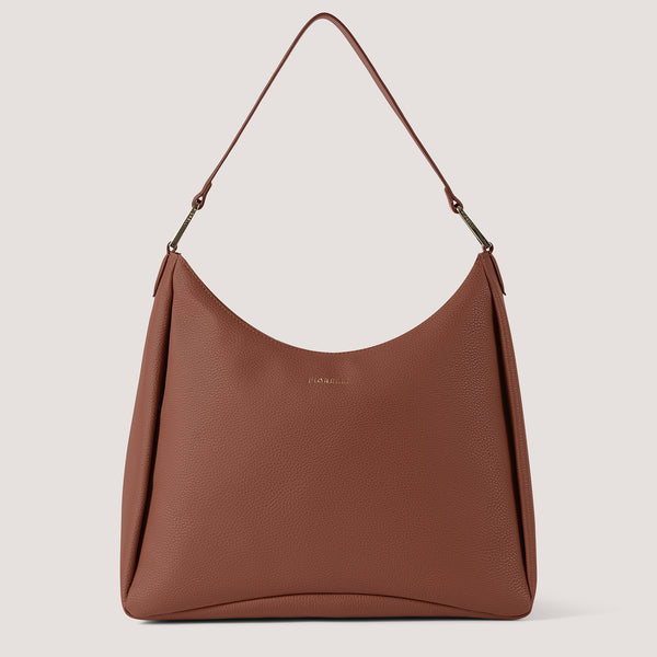 Tan slouchy hobo bag with elongated D-rings.