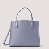 Steel blue tote bag with origami-inspired construction.