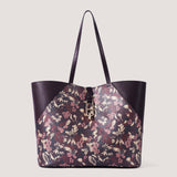 Metallic floral print large tote bag with twist lock detail.