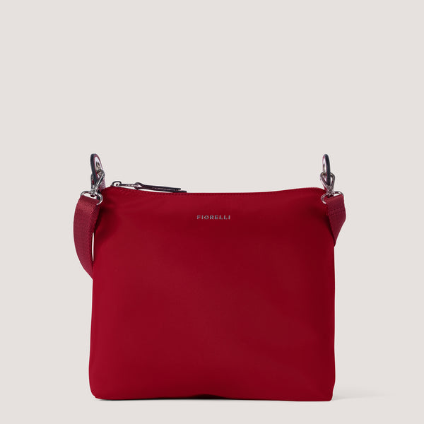 Red nylon crossbody bag with statement hardware.