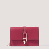 Red clutch bag with a detachable chain strap.