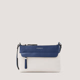 Light-stone and nautical-blue crossbody bag with concealed zip pocket.
