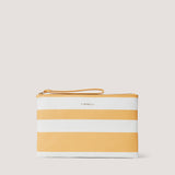 The Lana pouch features a beachy yellow and white stripes. Carry it by the wrist strap or tuck it neatly under your arm.