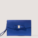 Metallic blue envelope clutch with bow detail.