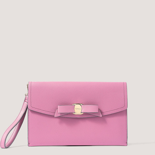 Pink envelope clutch with bow detail.