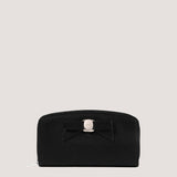 Black purse with bow detail.