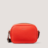 Updated for the new season, the orange camera-style Lyra crossbody bag has an adjustable webbing strap that lends a sporty feel.