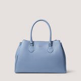 Designed to be worn multiple ways, the light-blue Paloma handbag can be worn across the body or in the crook of your arm.