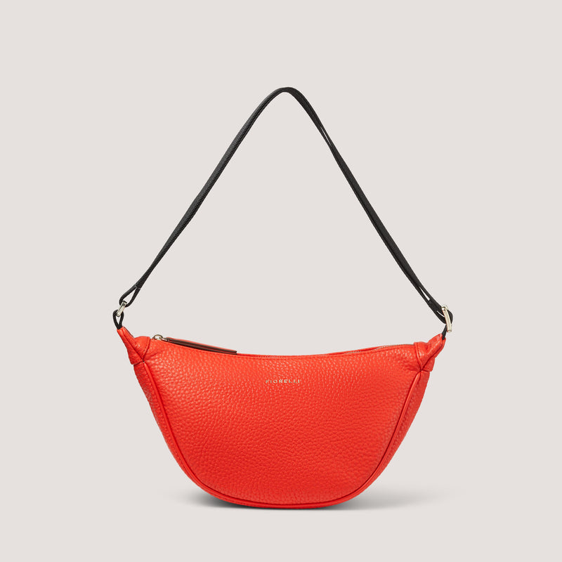 The Darcey bag in orange has been consciously designed to sit at an angle, so you can wear it on one shoulder or cross-body.